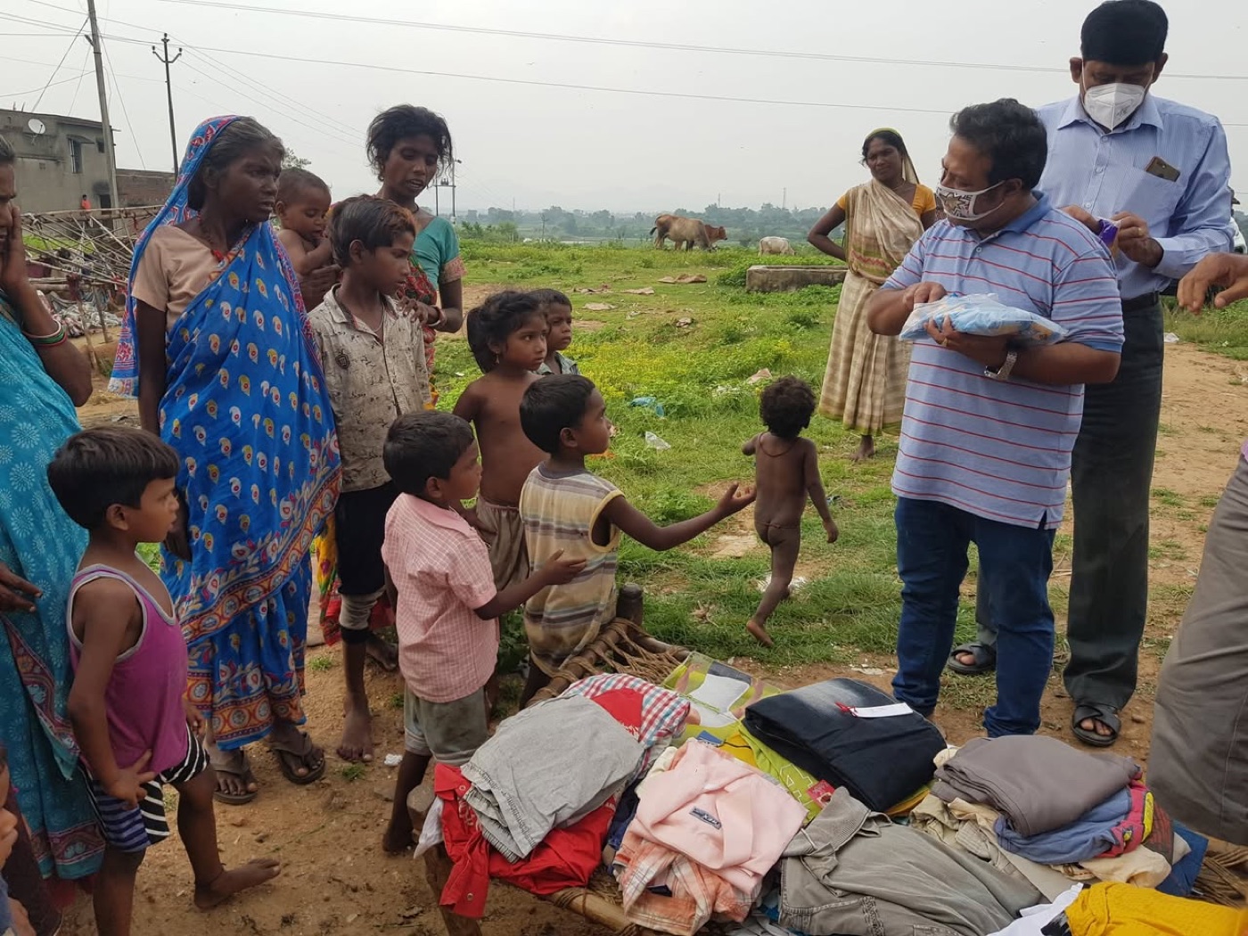 Villagers, mostly women and children, receiving clothes at MEM Foundation's first cloth distribution near Barwadda